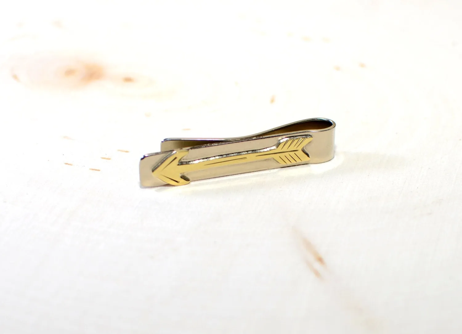Brass arrow on sterling silver tie clip