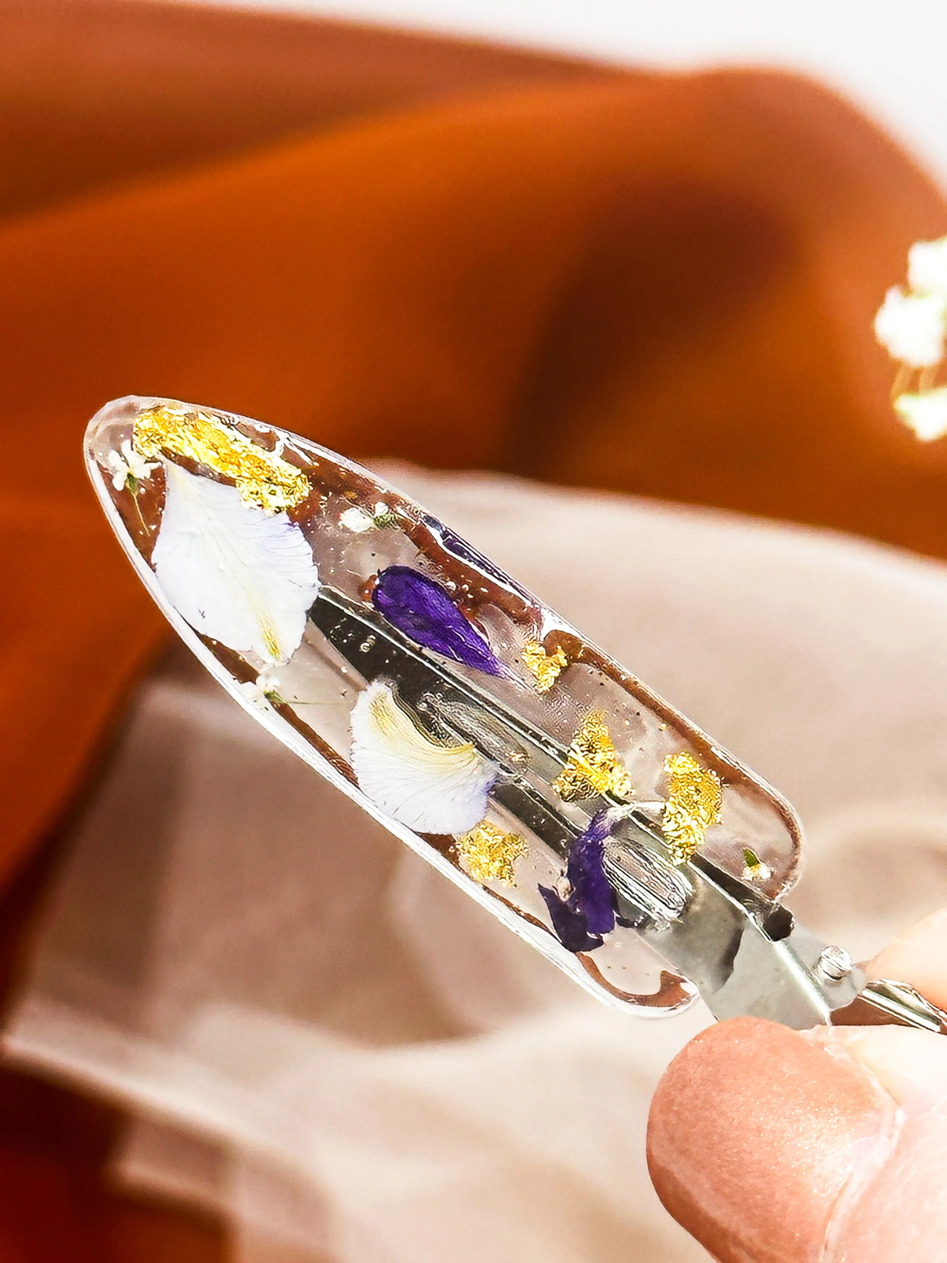 Clear No dent resin clip with Real Purple and Blue Toned Flowers Cast Inside.