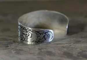 Hummingbird and flowers on a sterling silver cuff bracelet