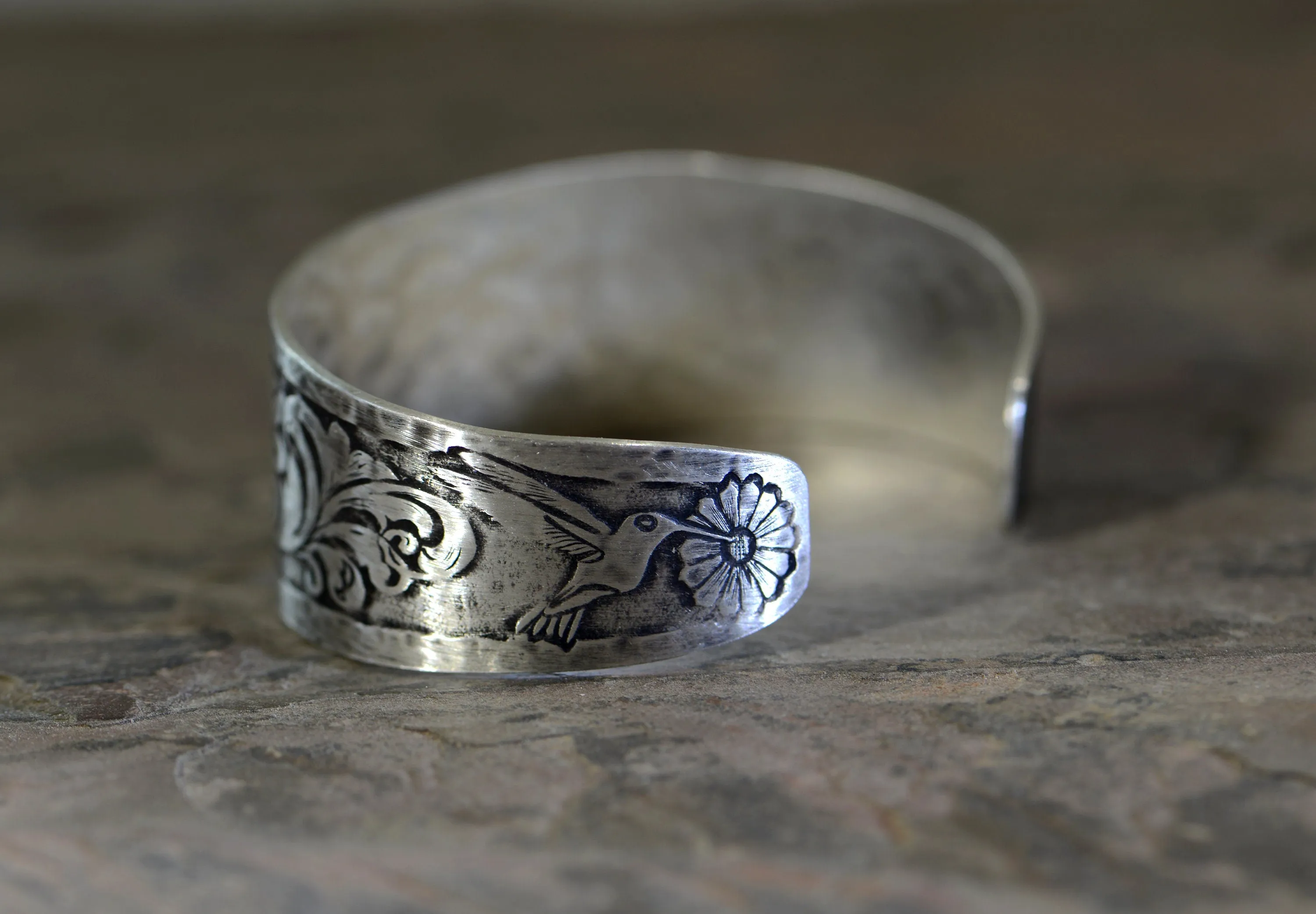 Hummingbird and flowers on a sterling silver cuff bracelet