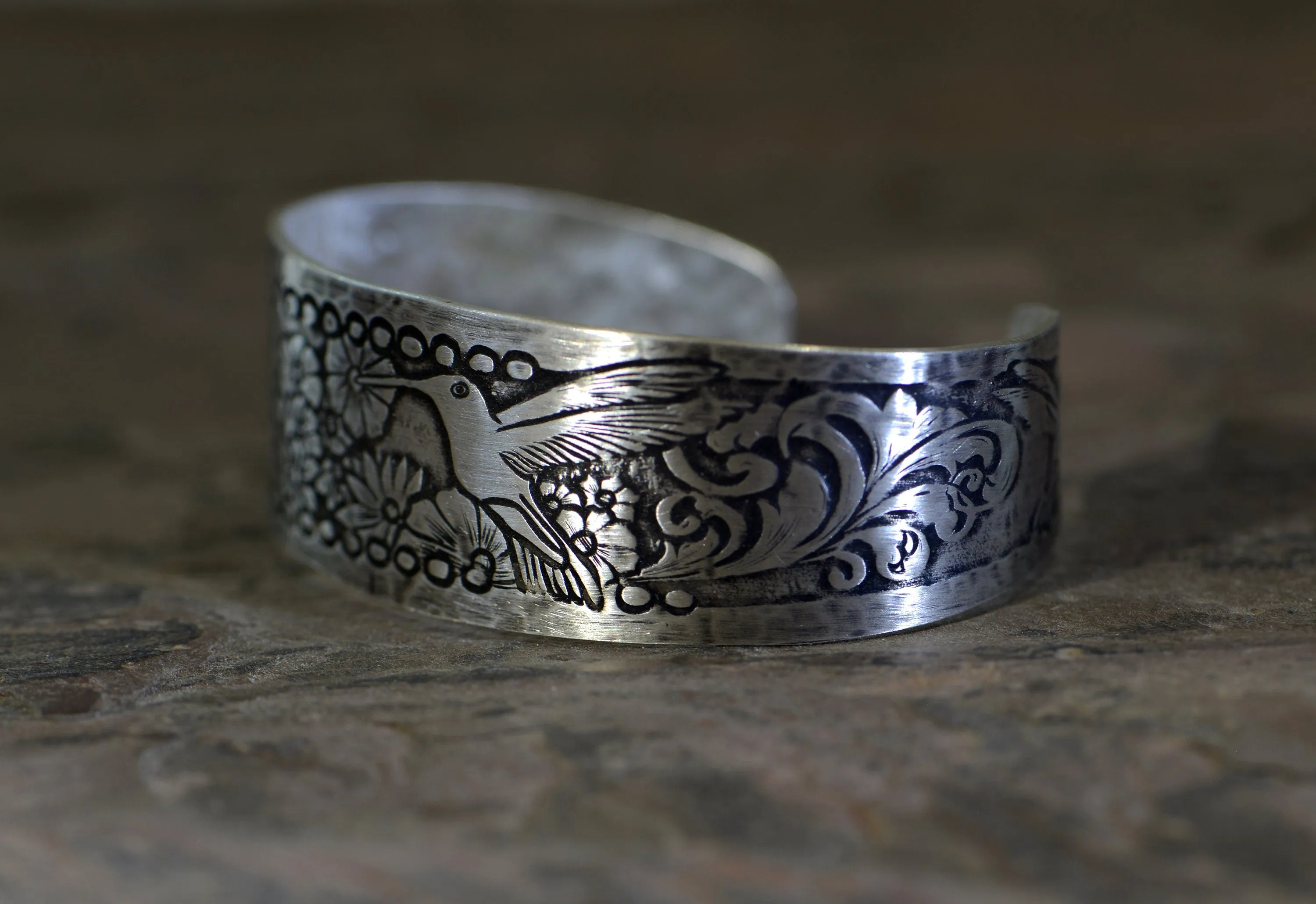 Hummingbird and flowers on a sterling silver cuff bracelet