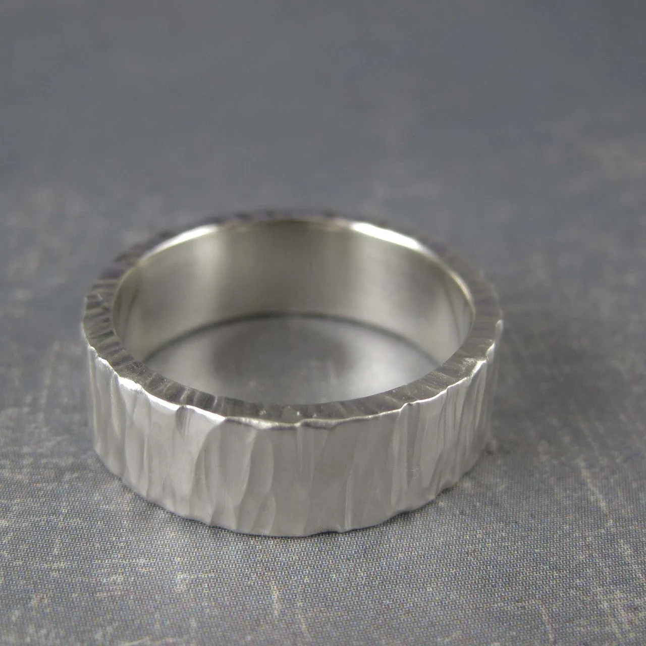 Rustic mens wedding band in carved tree bark pattern