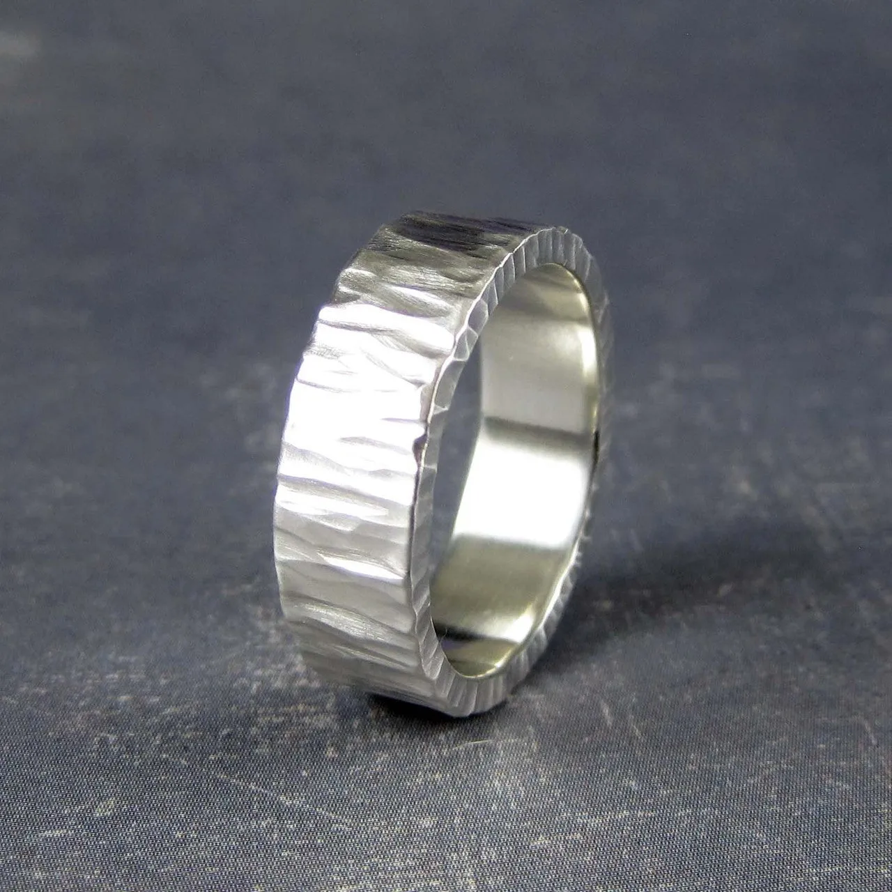 Rustic mens wedding band in carved tree bark pattern